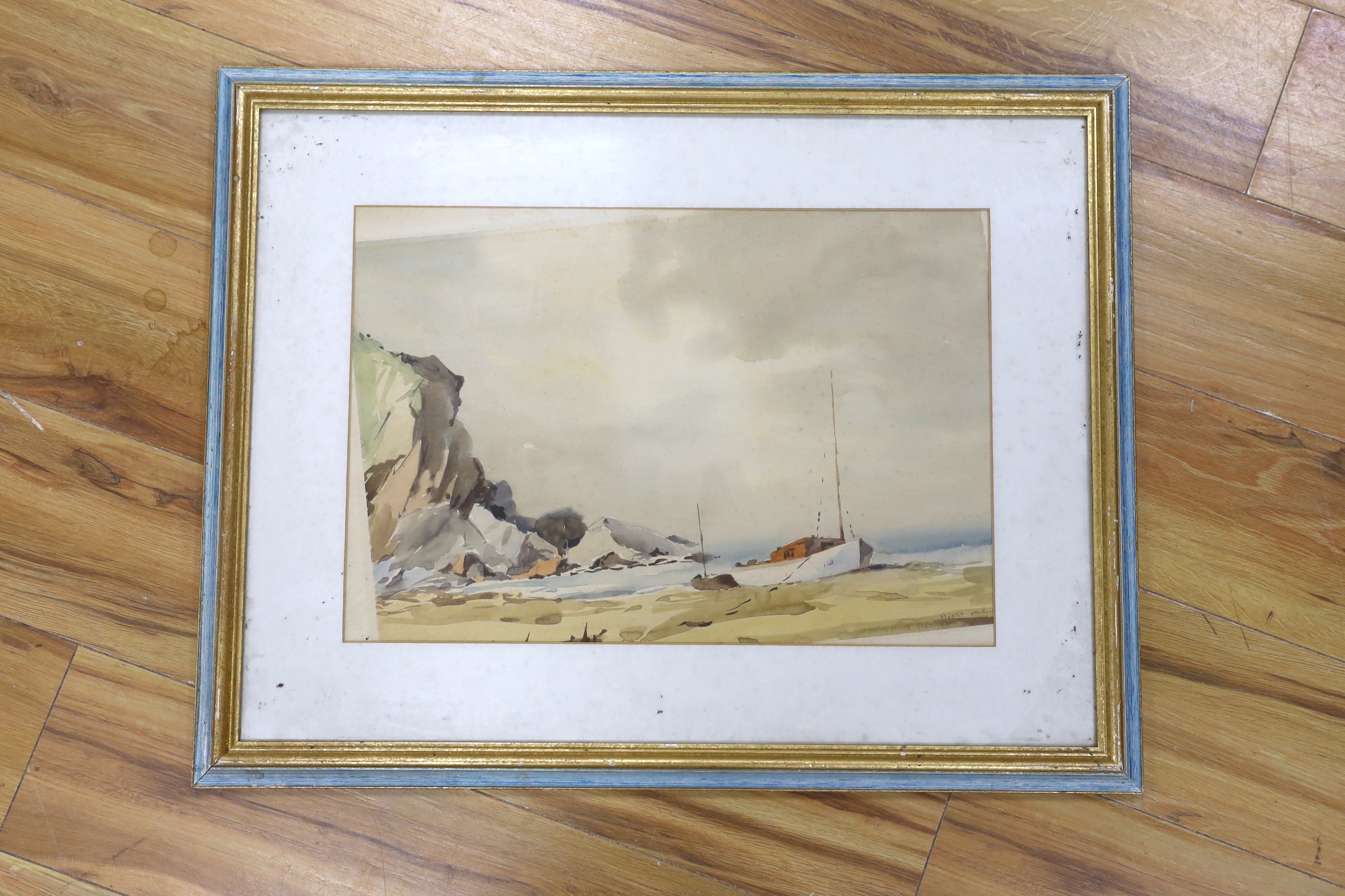 Sydney Vale (1916-1991), watercolour, coastal view with beached fishing boat, signed, 33 x 49cm